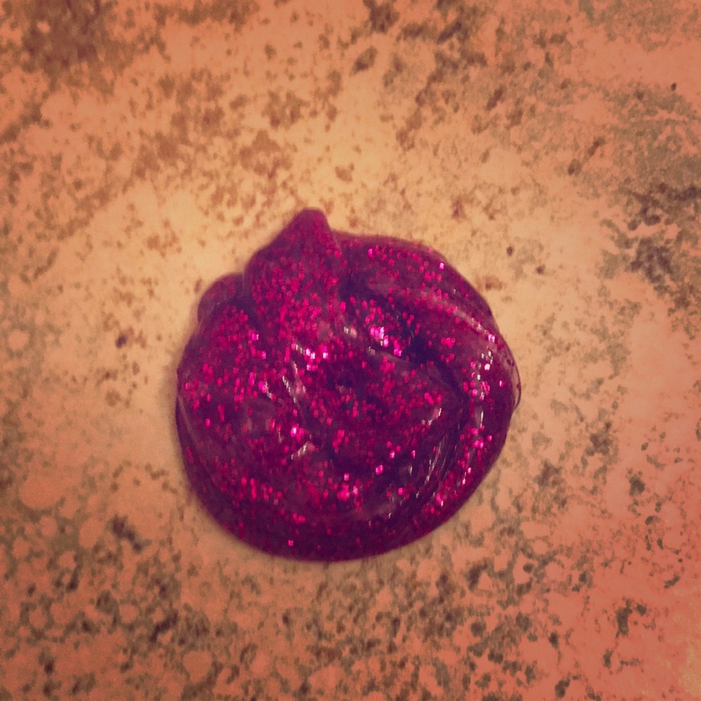 A clear purple glitter slime